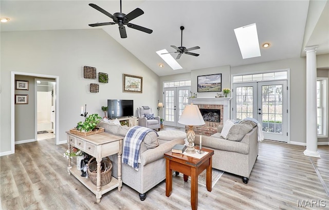 269 Bennington Dr, Troy, MO 63379 - living room with french doors, high vaulted ceiling, a ceiling fan, a skylight, and ornate columns