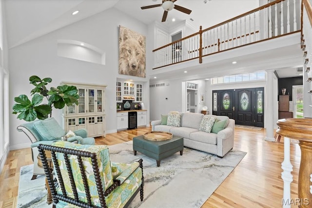261 US Dr, Wentzville, MO 63385 - living room featuring high vaulted ceiling, beverage cooler, ceiling fan, light wood finished floors, and a dry bar