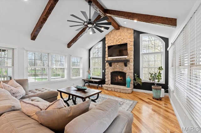 261 US Dr, Wentzville, MO 63385 - living room featuring healthy amount of natural light, ceiling fan, wood finished floors, and a stone fireplace