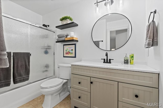 261 US Dr, Wentzville, MO 63385 - full bath with tile patterned flooring, vanity, toilet, and combined bath / shower with glass door