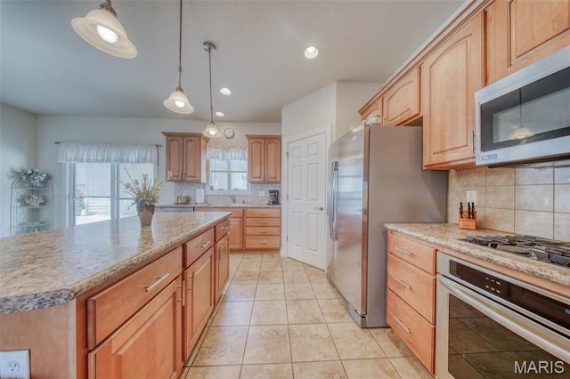 17205 Elk Prairie Dr, Rolla, MO 65401 - kitchen with appliances with stainless steel finishes, decorative backsplash, light tile patterned floors, hanging light fixtures, and recessed lighting
