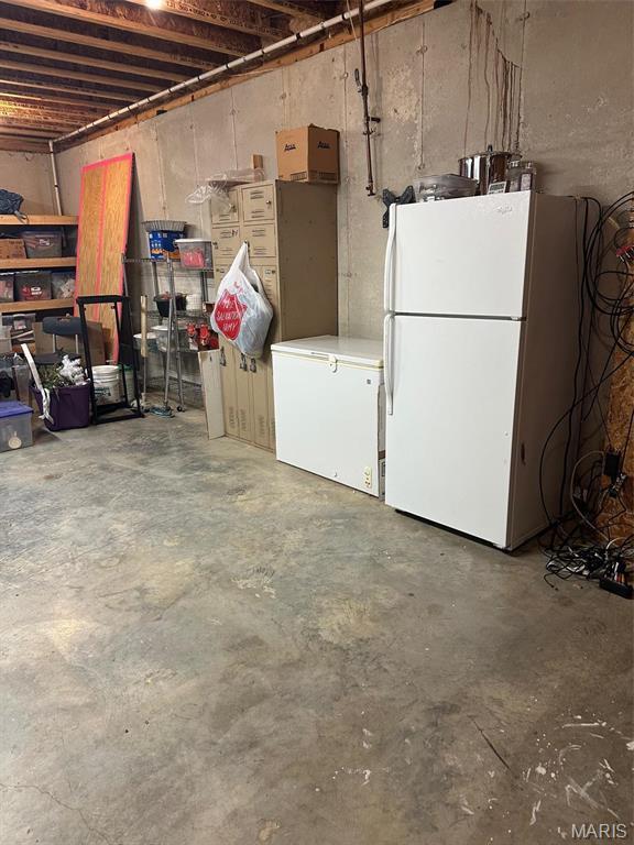 17205 Elk Prairie Dr, Rolla, MO 65401 - unfinished below grade area with freestanding refrigerator and white fridge