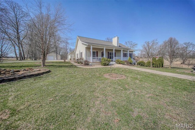17205 Elk Prairie Dr, Rolla, MO 65401 - view of front facade featuring a porch, a chimney, a front yard, and an outdoor structure