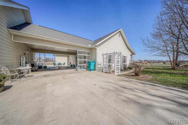 17205 Elk Prairie Dr, Rolla, MO 65401 - view of home's exterior with a patio area and roof with shingles