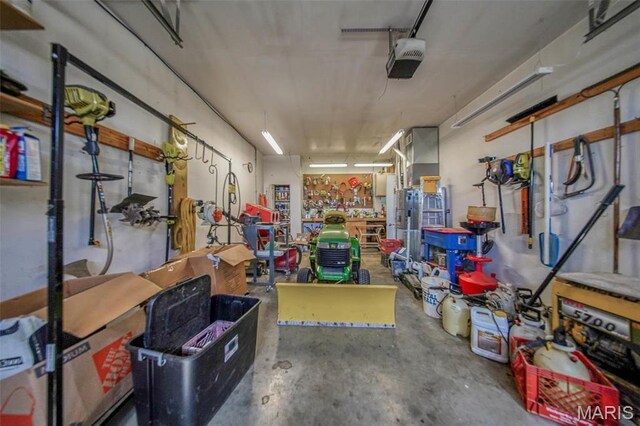 17205 Elk Prairie Dr, Rolla, MO 65401 - garage with a workshop area and a garage door opener
