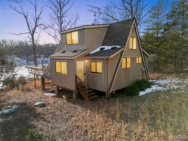 372 Alpine Lake Dr, Wright City, MO 63390 - back of property at dusk with roof with shingles
