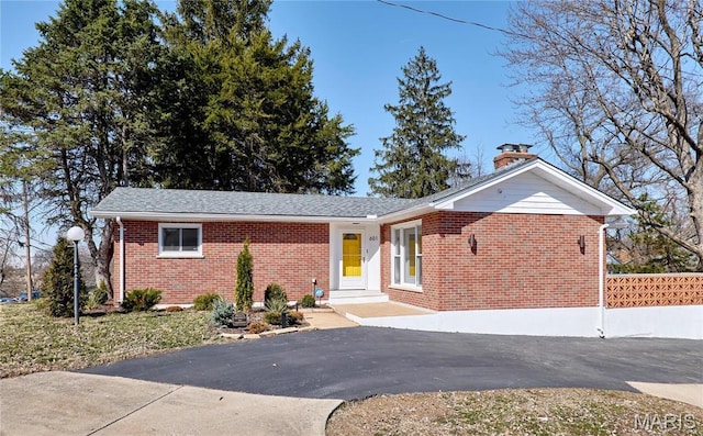 601 Brotherton Ln, Saint Louis, MO 63135 - ranch-style house with brick siding, a chimney, asphalt driveway, and roof with shingles