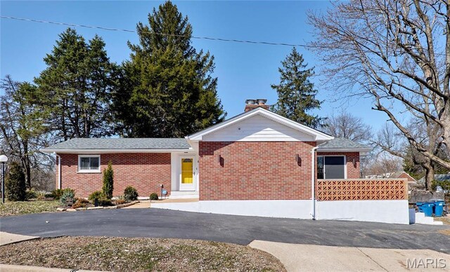 601 Brotherton Ln, Saint Louis, MO 63135 - ranch-style home featuring a chimney, brick siding, and driveway