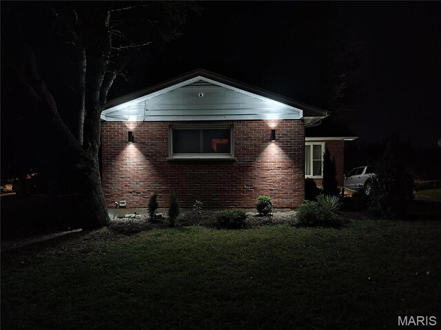 601 Brotherton Ln, Saint Louis, MO 63135 - property exterior at night with brick siding and a lawn