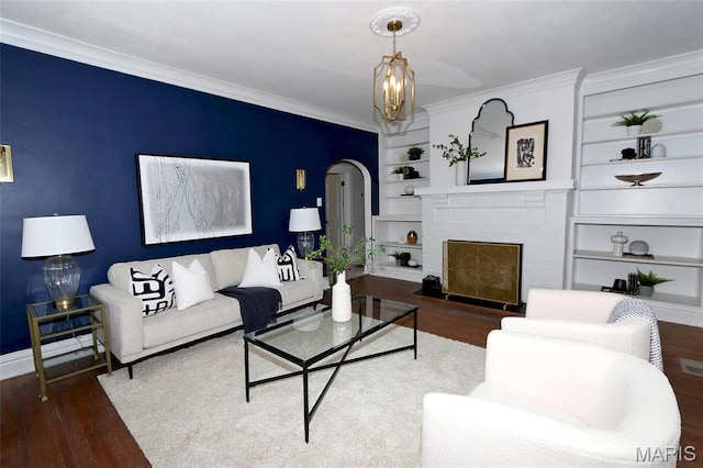 3092 Bellerive Dr, Saint Louis, MO 63121 - living area featuring wood finished floors, arched walkways, crown molding, baseboards, and built in features