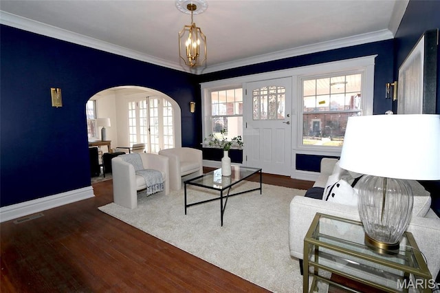 3092 Bellerive Dr, Saint Louis, MO 63121 - living area with arched walkways, wood finished floors, ornamental molding, a chandelier, and baseboards
