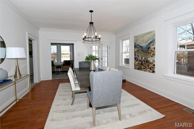 3092 Bellerive Dr, Saint Louis, MO 63121 - dining space featuring a chandelier, dark wood-style flooring, and crown molding