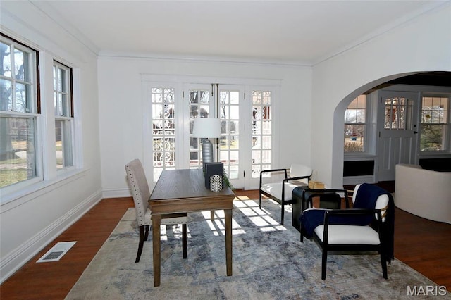 3092 Bellerive Dr, Saint Louis, MO 63121 - dining space with wood finished floors, ornamental molding, healthy amount of natural light, arched walkways, and baseboards