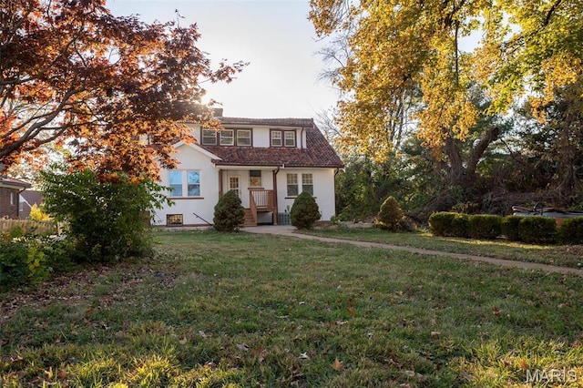 3092 Bellerive Dr, Saint Louis, MO 63121 - view of front of house with stucco siding, a front lawn, and a chimney