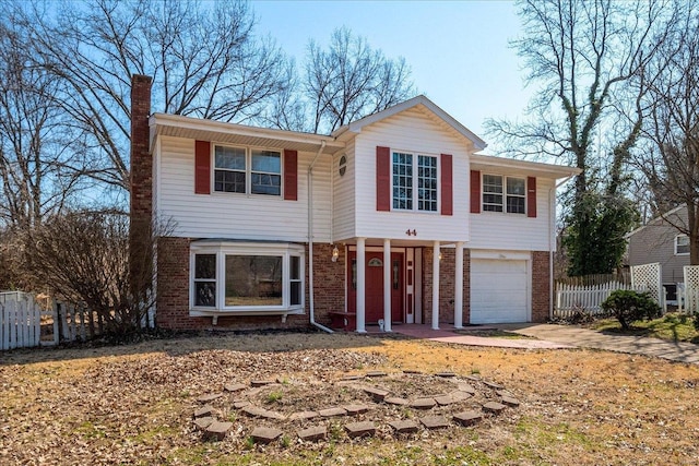 44 Potomac Dr, Fairview Heights, IL 62208 - view of front of house featuring brick siding, fence, a chimney, concrete driveway, and a garage