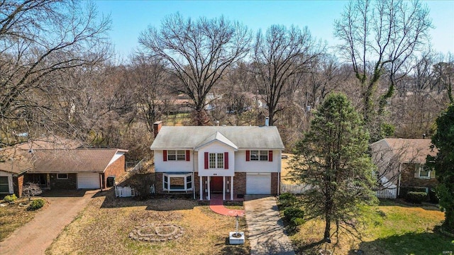 44 Potomac Dr, Fairview Heights, IL 62208 - traditional-style house with dirt driveway, a garage, brick siding, and fence