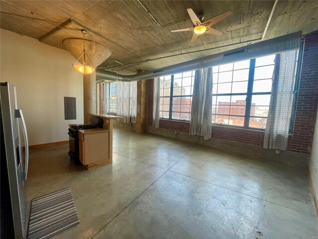 unfurnished room featuring finished concrete flooring, electric panel, and a ceiling fan