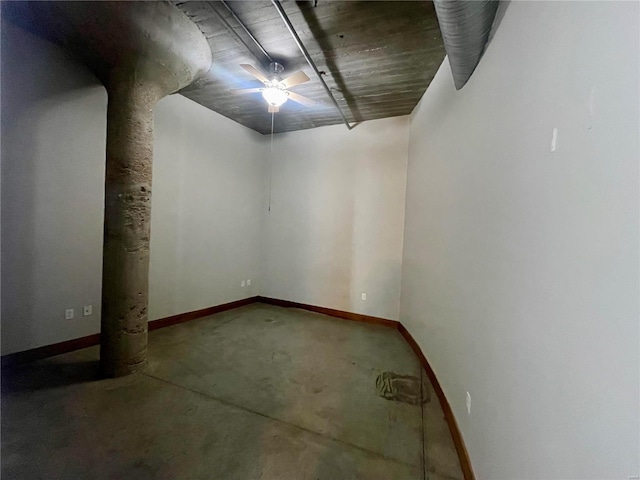 basement featuring ceiling fan and baseboards