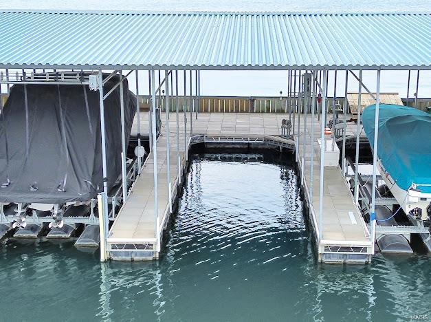 dock area with a water view and boat lift