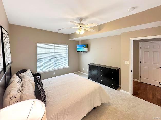 bedroom with carpet floors, baseboards, and a ceiling fan