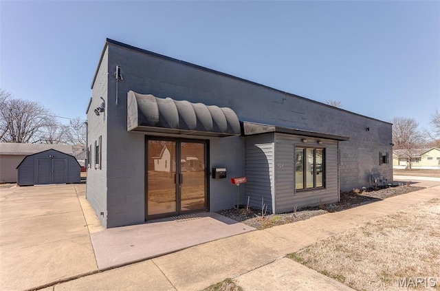 424 N College St, Centralia, IL 62801 - rear view of house featuring concrete block siding and a storage shed