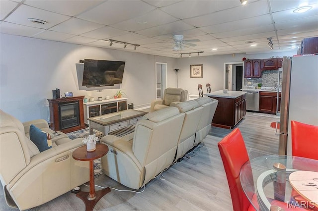 424 N College St, Centralia, IL 62801 - living area featuring light wood-style flooring, ceiling fan, and a paneled ceiling