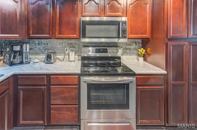 424 N College St, Centralia, IL 62801 - kitchen featuring stainless steel appliances, light countertops, and backsplash
