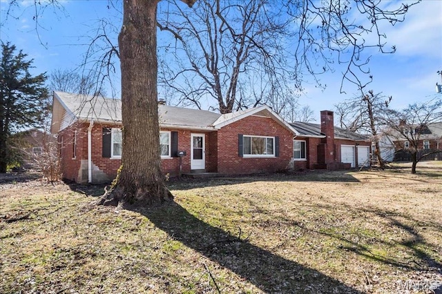 7304 Northern Dr, Belleville, IL 62223 - ranch-style house with brick siding, a front yard, an attached garage, and a chimney