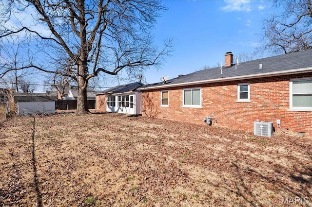 7304 Northern Dr, Belleville, IL 62223 - rear view of property with brick siding, a chimney, and central AC unit
