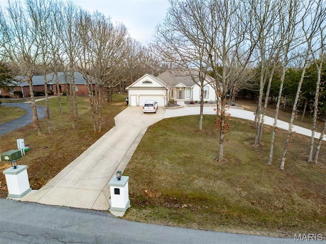 view of front of home with concrete driveway, an attached garage, and a front lawn