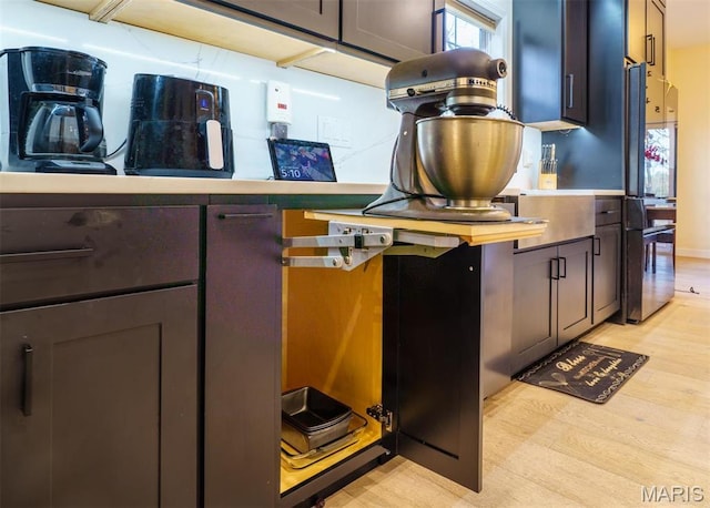 kitchen view of light wood-style flooring and light countertops