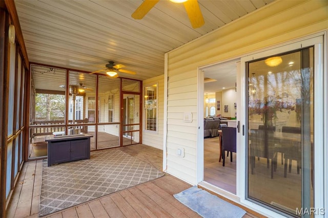 sunroom featuring ceiling fan