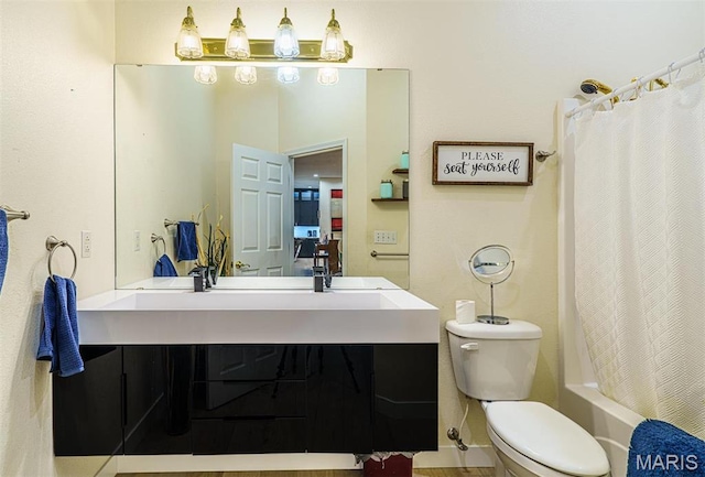 full bath with toilet, vanity, and shower / bath combination with curtain