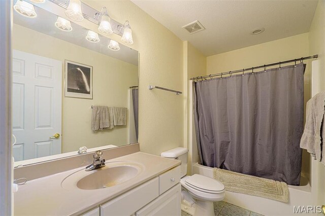 full bathroom featuring toilet, tile patterned flooring, vanity, and shower / bath combo