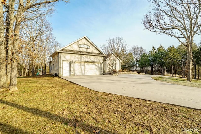 view of home's exterior featuring driveway, a yard, and a garage
