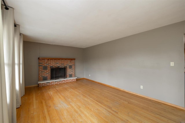 762 Cave Farm Rd, Troy, MO 63379 - unfurnished living room featuring light wood finished floors, baseboards, and a fireplace