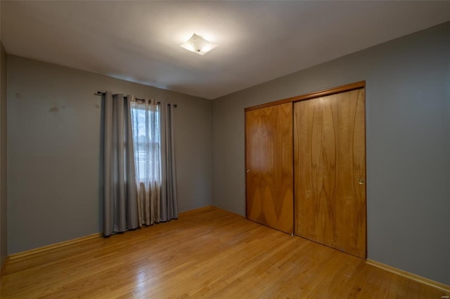 762 Cave Farm Rd, Troy, MO 63379 - unfurnished bedroom with light wood finished floors and a closet