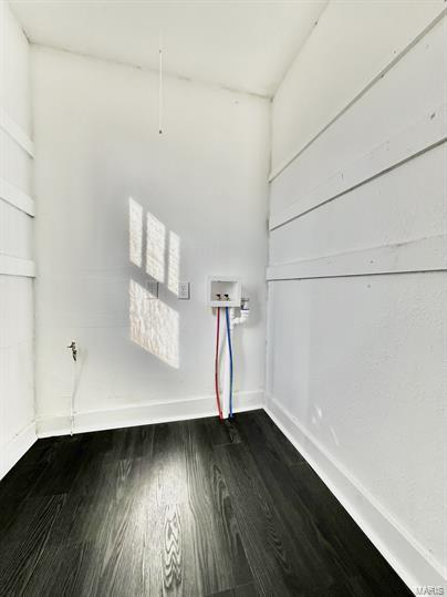 unfurnished room with dark wood-style floors and baseboards