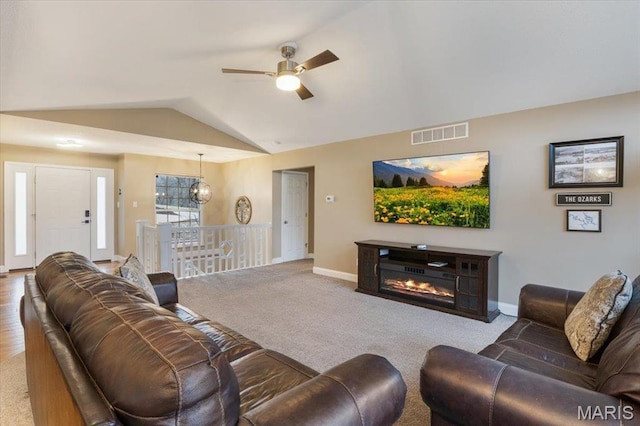 1500 Swiss Village Rd, Osage Beach, MO 65065 - living room with lofted ceiling, ceiling fan, carpet, and a glass covered fireplace