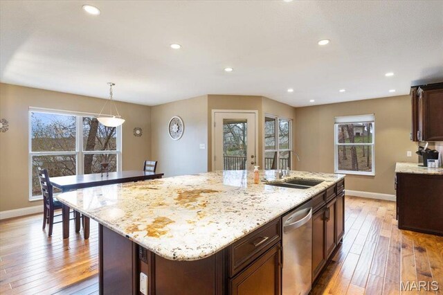 1500 Swiss Village Rd, Osage Beach, MO 65065 - kitchen with dishwasher, light wood-type flooring, an island with sink, light stone countertops, and recessed lighting