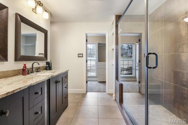 1500 Swiss Village Rd, Osage Beach, MO 65065 - bathroom with vanity, tile patterned flooring, healthy amount of natural light, a stall shower, and a textured ceiling