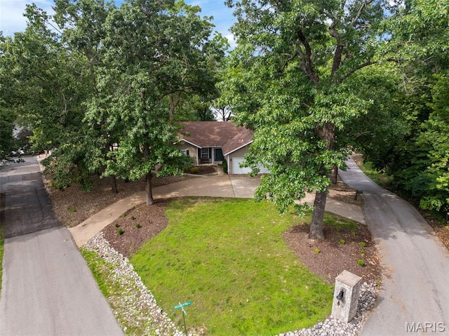 1500 Swiss Village Rd, Osage Beach, MO 65065 - view of front of home featuring a front yard, a garage, and concrete driveway