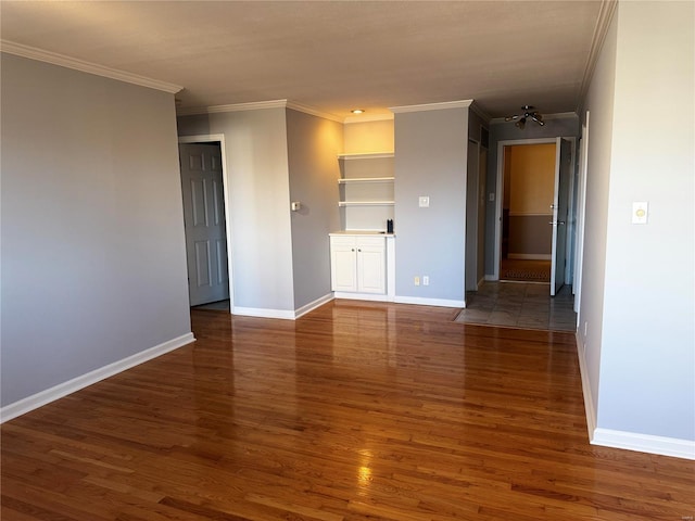 8631 Old Bonhomme Rd Unit 3E, Saint Louis, MO 63132 - empty room featuring crown molding, wood finished floors, baseboards, and built in shelves