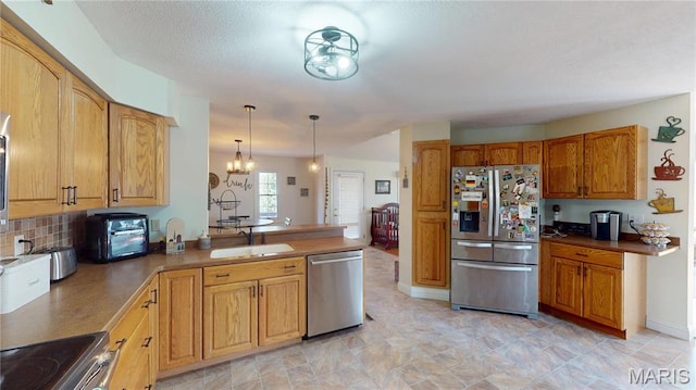 20 Denzel Dr, Greenville, IL 62246 - kitchen featuring appliances with stainless steel finishes, a sink, a peninsula, a chandelier, and hanging light fixtures