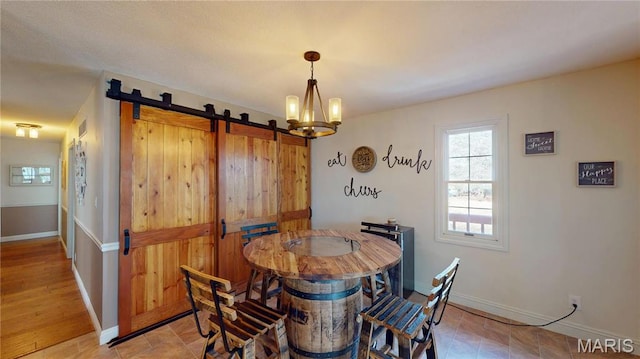 20 Denzel Dr, Greenville, IL 62246 - dining room with baseboards, a chandelier, and a barn door