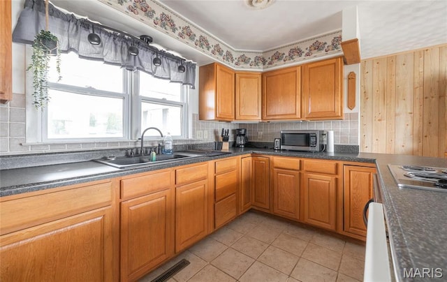 24265 Vinyard Rd, Cuba, MO 65453 - kitchen with stainless steel appliances, a sink, dark countertops, and tasteful backsplash