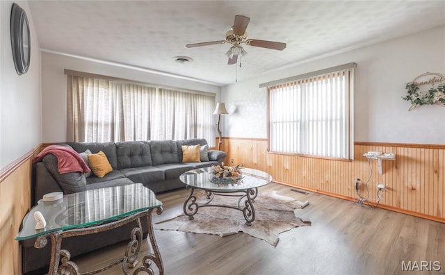 24265 Vinyard Rd, Cuba, MO 65453 - living room with wainscoting, a ceiling fan, wood finished floors, and wood walls