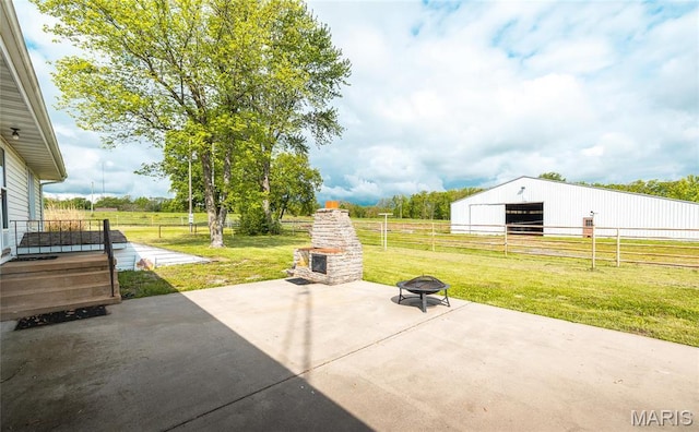 24265 Vinyard Rd, Cuba, MO 65453 - view of patio featuring a detached garage, a pole building, an outdoor structure, and a view of rural / pastoral area