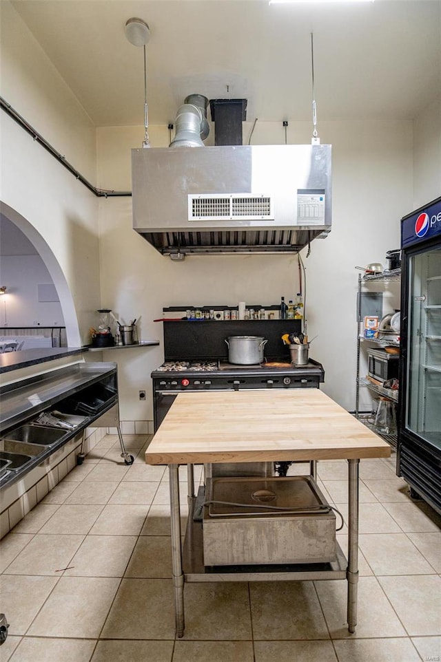 kitchen with light tile patterned floors and arched walkways