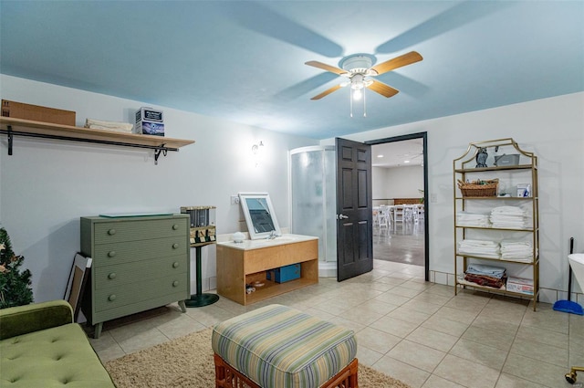 living room with light tile patterned floors and a ceiling fan